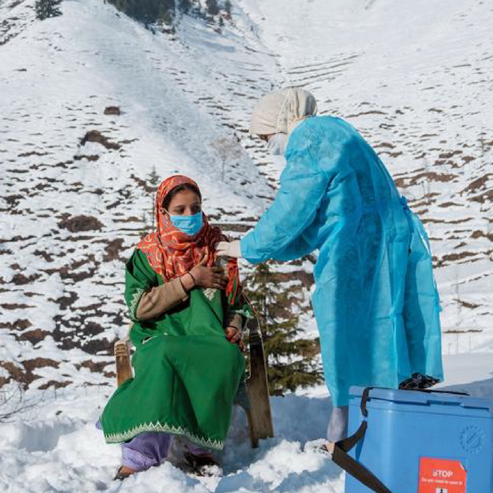 A healthcare worker from a clinic in North Kashmir braves freezing temperatures and snow to vaccinate people living in remote areas of India.