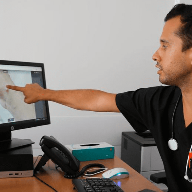 A doctor looks at an image of a monkeypox lesion on his computer screen at a sexual health clinic in Lisbon, Portugal.