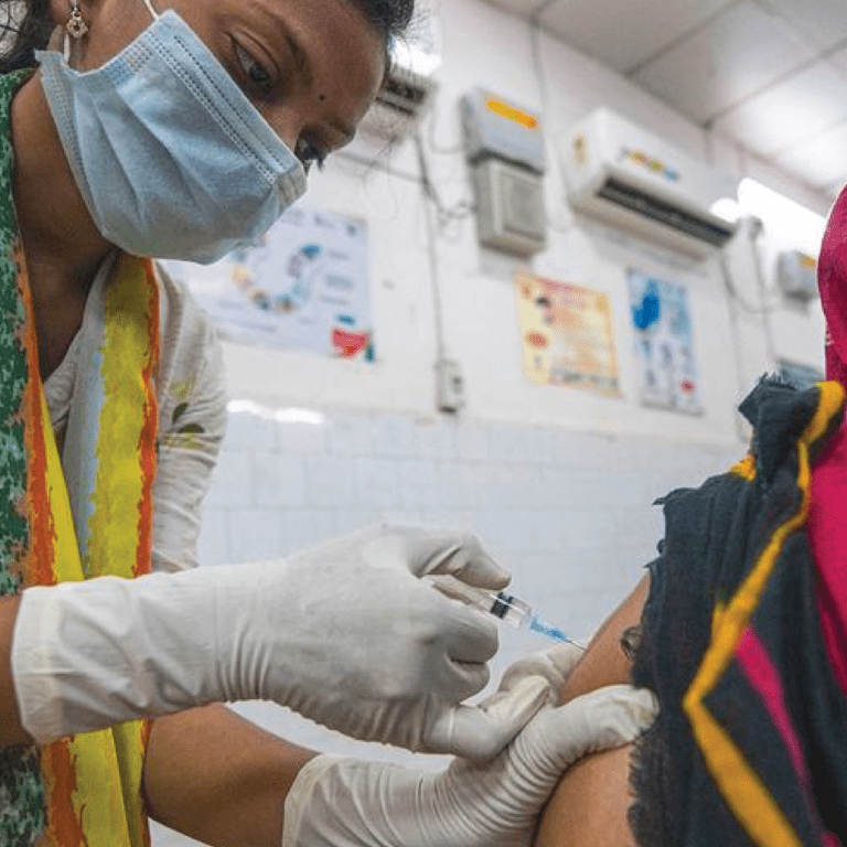 COVID-19 vaccinations are administered at a hospital in Odisha, India.