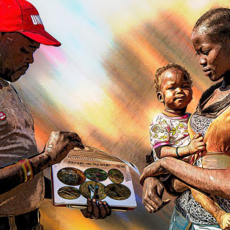 An UN Mine Action Service (UNMAS) community liaison officer, talks to a woman in South Sudan about the danger of mines.