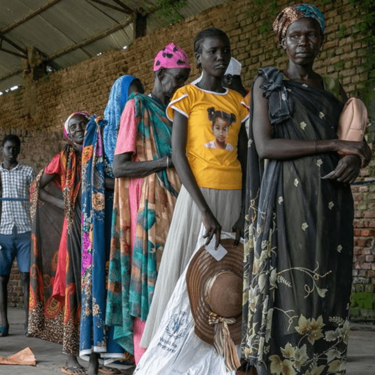 People wait in line at a food distribution site in Malakal, South Sudan.