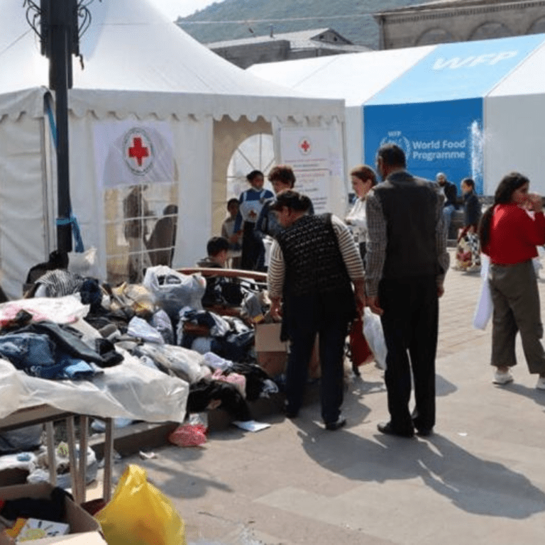 People fleeing Karabakh rest and receive humanitarian aid in Goris, Armenia.