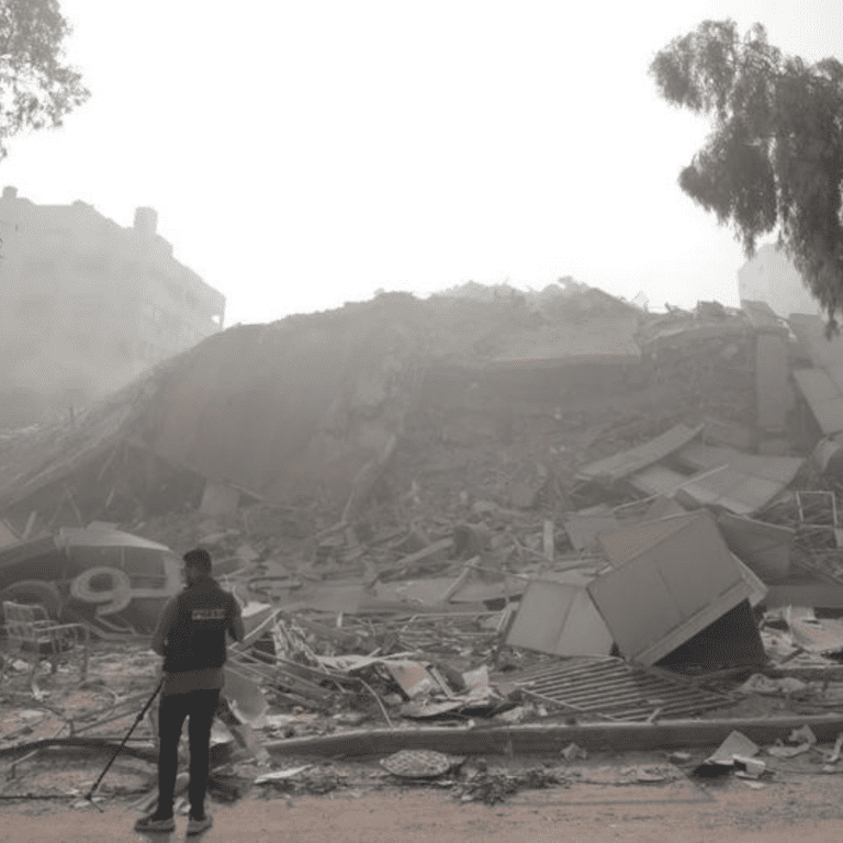 A man looks over a collapsed building in Gaza.