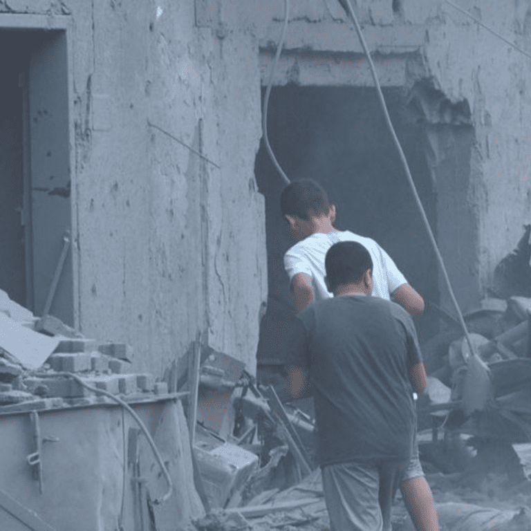 Two men approach a building in central Gaza which was reportedly struck by missiles.