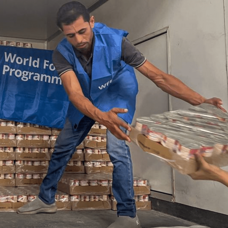 A worker unloads ready-to-eat rations from a truck close to Alexandria, Egypt, in preparation for delivery to Gaza.