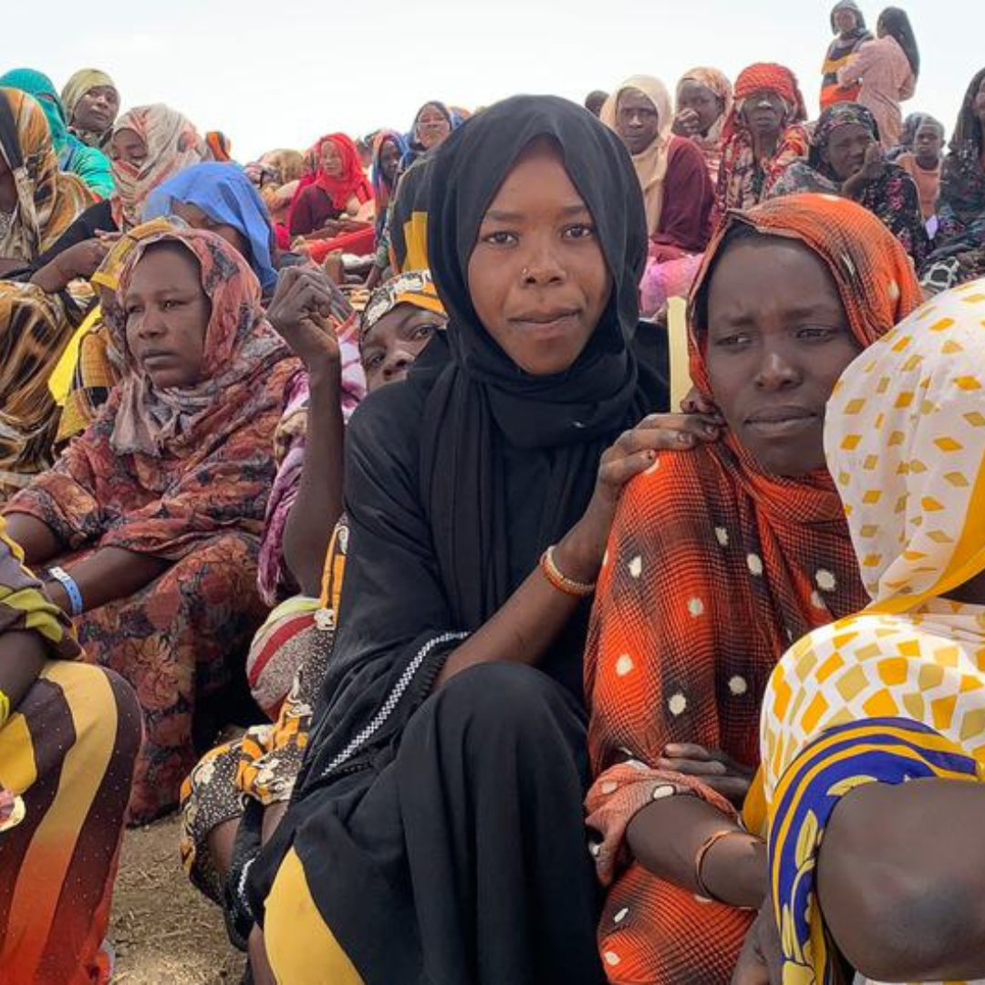 Refugees from Sudan wait to collect aid items in a border village in Chad.