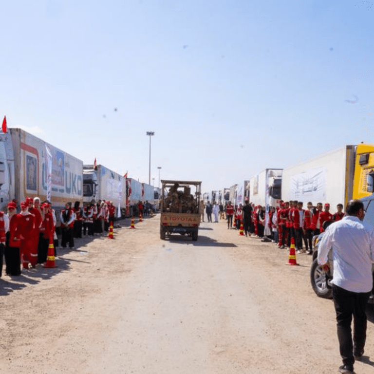 Trucks carrying humanitarian aid wait to cross into Gaza from Egypt through Rafah.