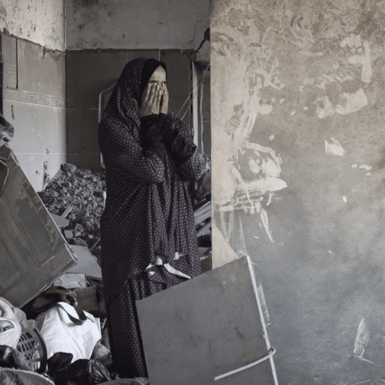 A woman visists her bombed out house in Rafah city in the southern Gaza Strip.