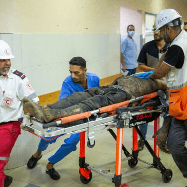 A man injured in a missile attack is rushed for treatment in Naser hospital in Khan Younis.