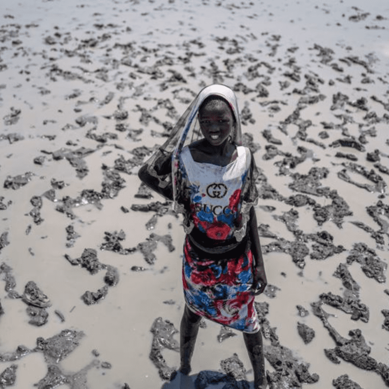 A young girl walks in the flooded village of Ulang in South Sudan.