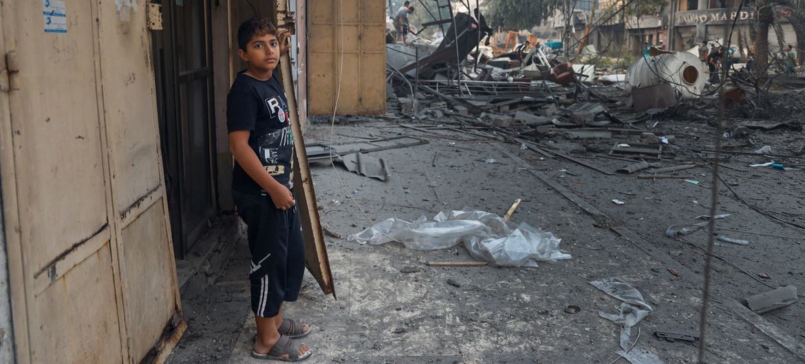 An 11-year-old boy stands at the entrance to his home in Gaza City. 
