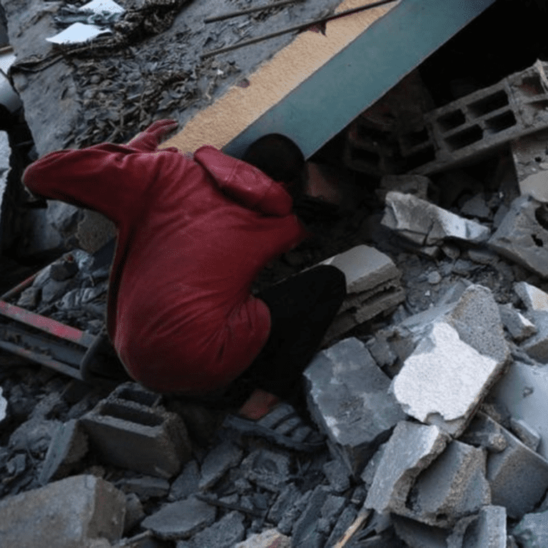 People search for their belongings in the rubble in the Nuseirat refugee camp in Gaza.