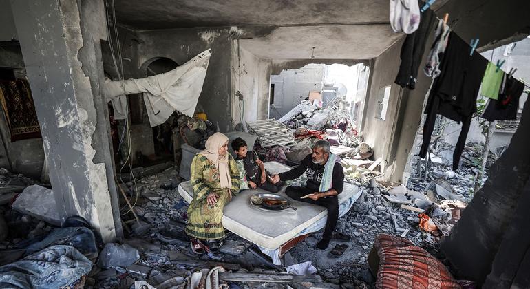 A family cooks in the rubble of their home in the Gaza Strip.