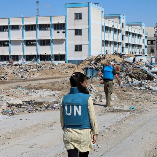 A UN team inspects a destroyed school in Khan Younis.